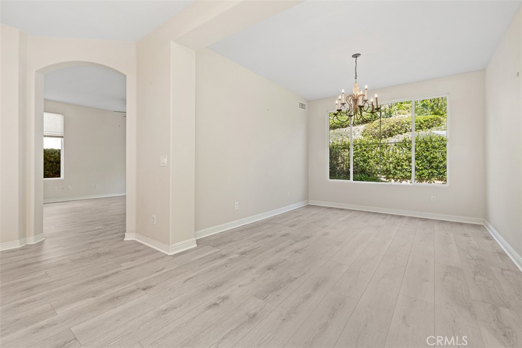 27806 Homestead Road Laguna Niguel, CA 92677 - Photo 9 of 52 an empty room with wooden floor and windows