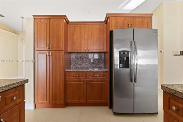 a kitchen with metallic refrigerator freezer and a dishwasher