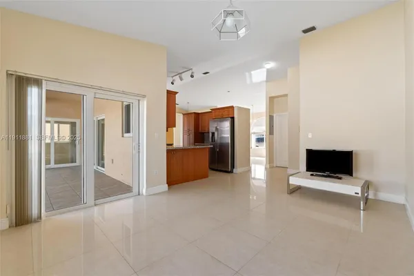 a view of a kitchen with refrigerator and windows
