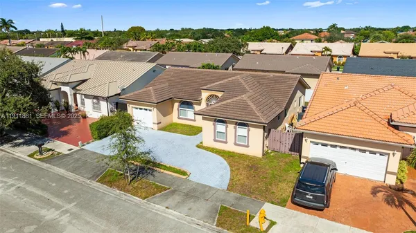 an aerial view of residential houses with outdoor space