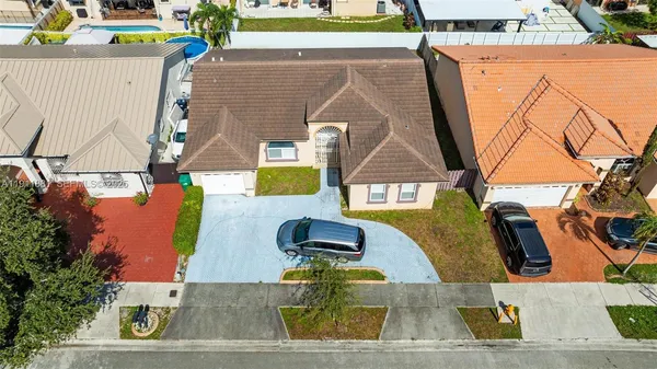 an aerial view of a house with a swimming pool