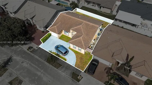 an aerial view of residential houses with outdoor space