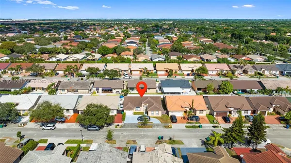 an aerial view of residential houses with outdoor space
