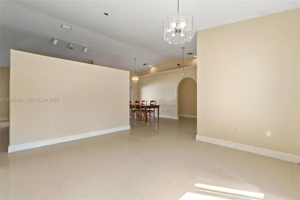 a view of a dining room with furniture and a chandelier