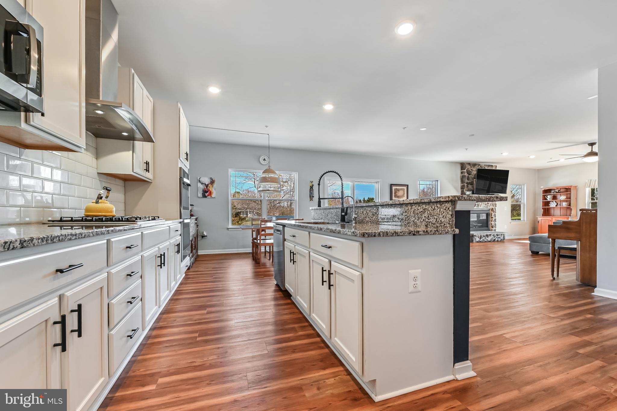5559 Trafalgar Circle Tilghman, MD 21671 - Photo 14 of 62 a kitchen with stainless steel appliances granite countertop lots of counter top space and cabinets