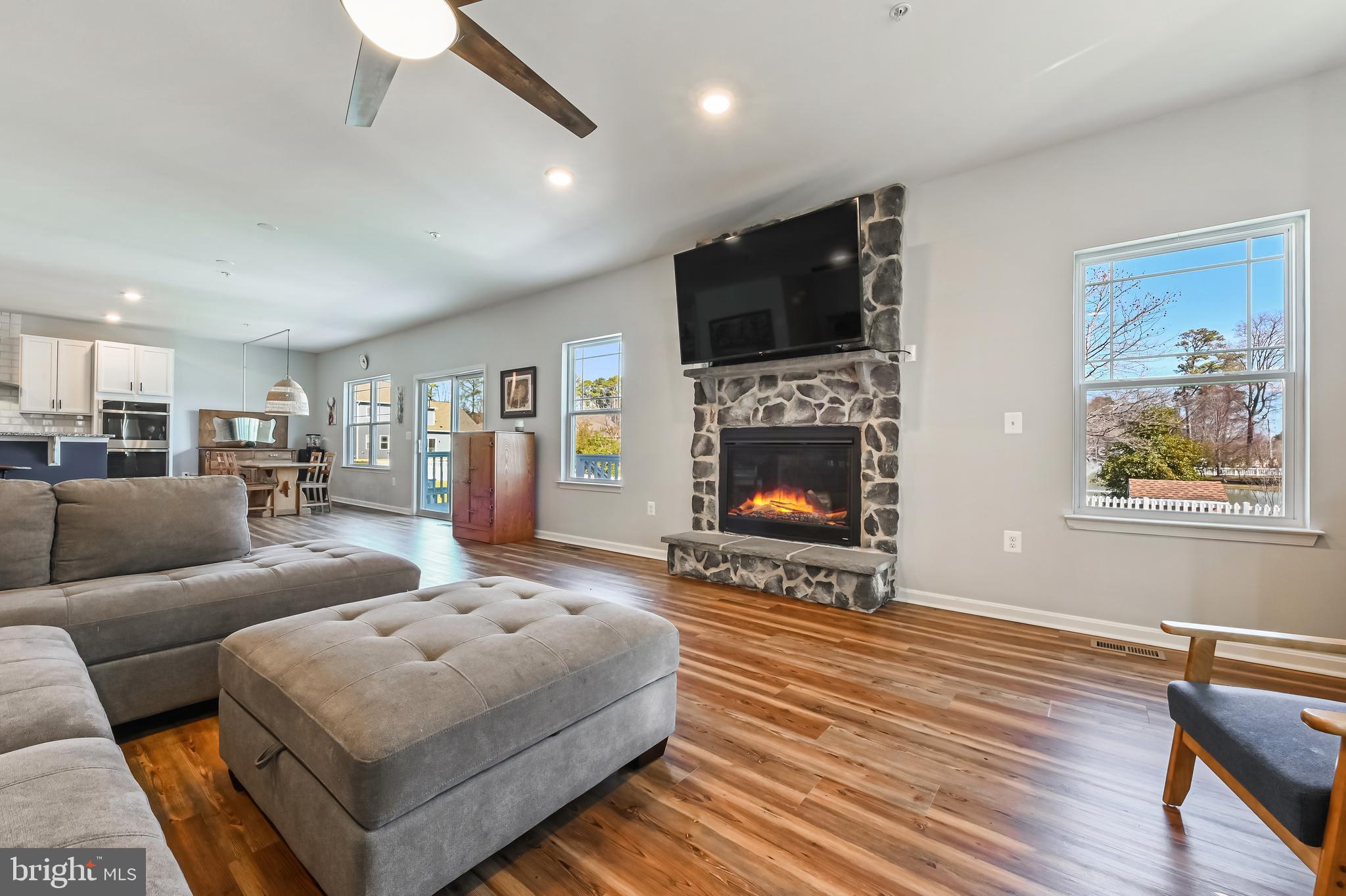 5559 Trafalgar Circle Tilghman, MD 21671 - Photo 26 of 62 a living room with furniture a flat screen tv and a fireplace