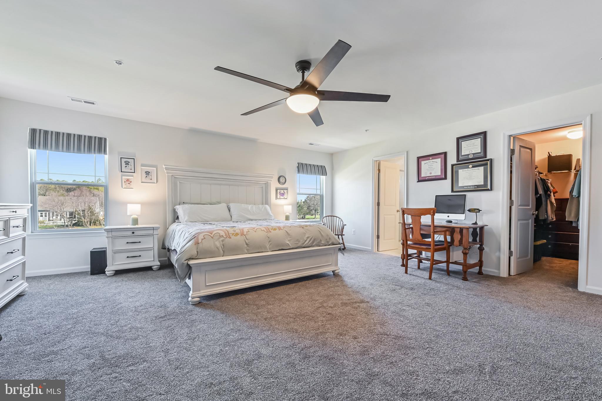 5559 Trafalgar Circle Tilghman, MD 21671 - Photo 27 of 62 a spacious bedroom with a bed and a chandelier
