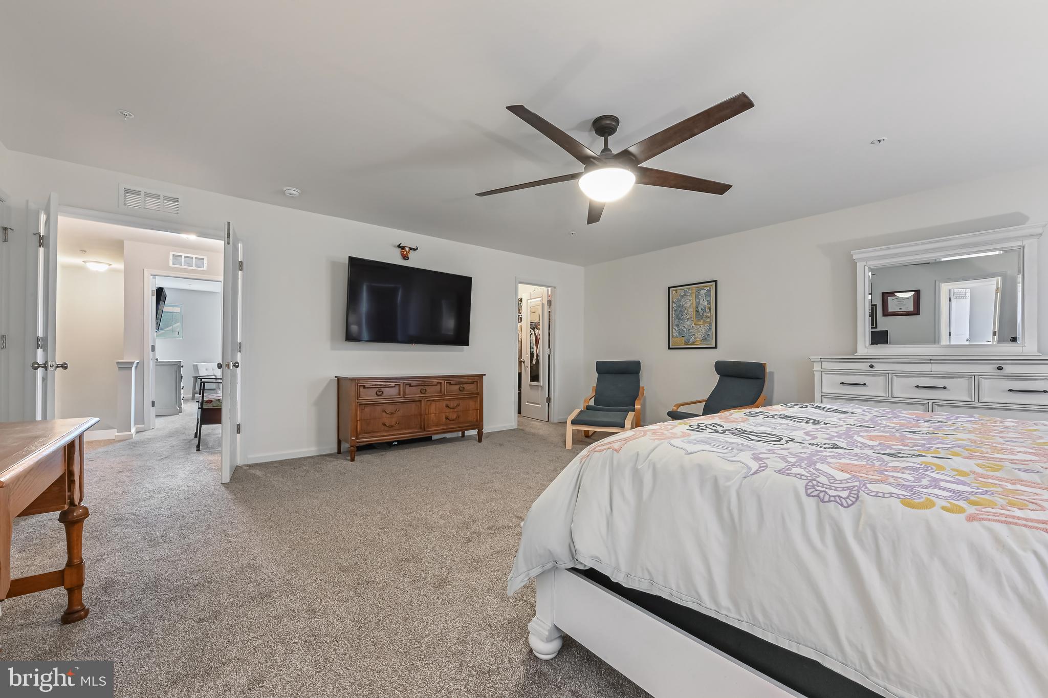 5559 Trafalgar Circle Tilghman, MD 21671 - Photo 30 of 62 a spacious bedroom with a bed and a flat screen tv