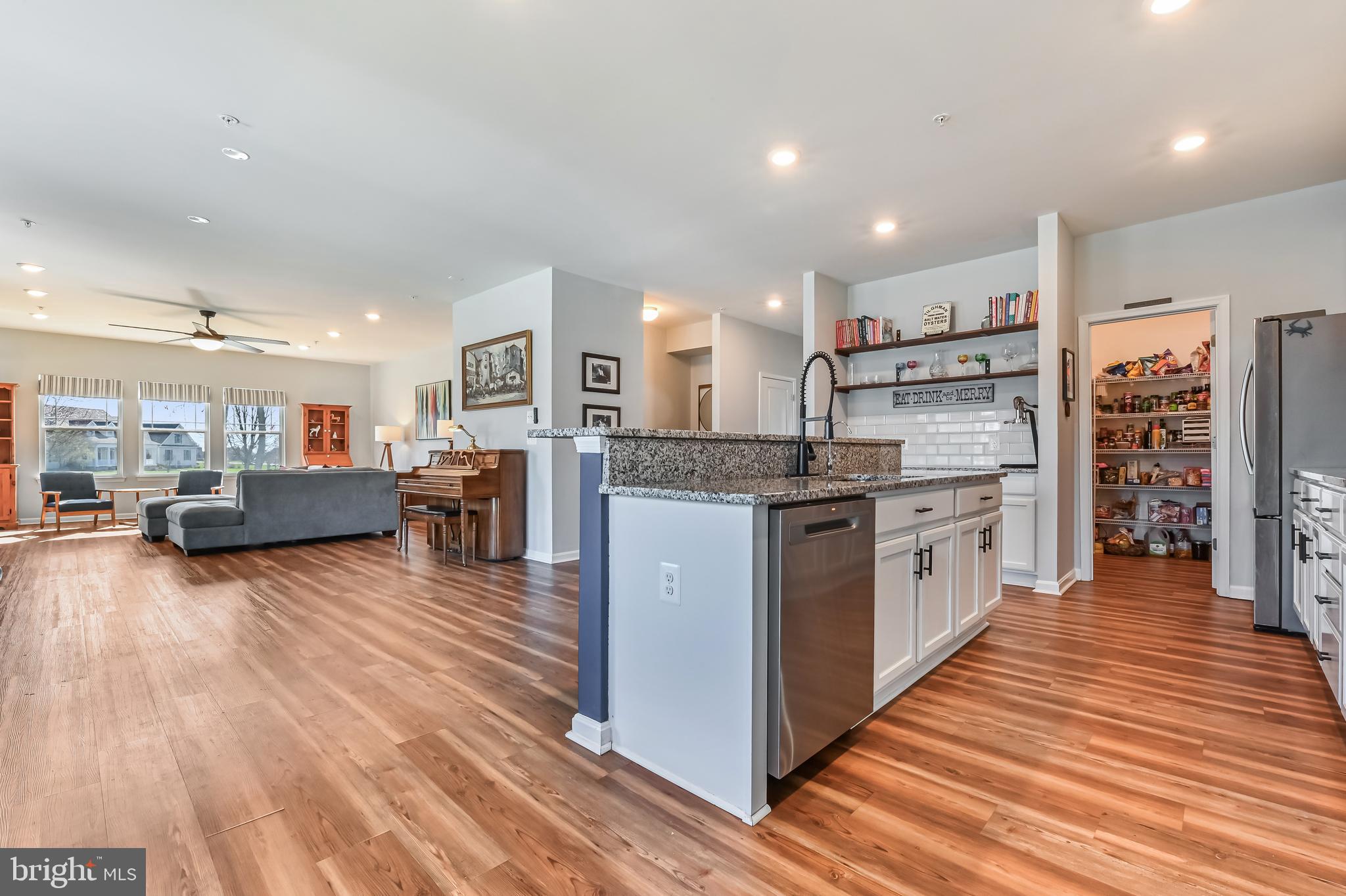 5559 Trafalgar Circle Tilghman, MD 21671 - Photo 9 of 62 a kitchen with stainless steel appliances granite countertop wooden floors and view living room