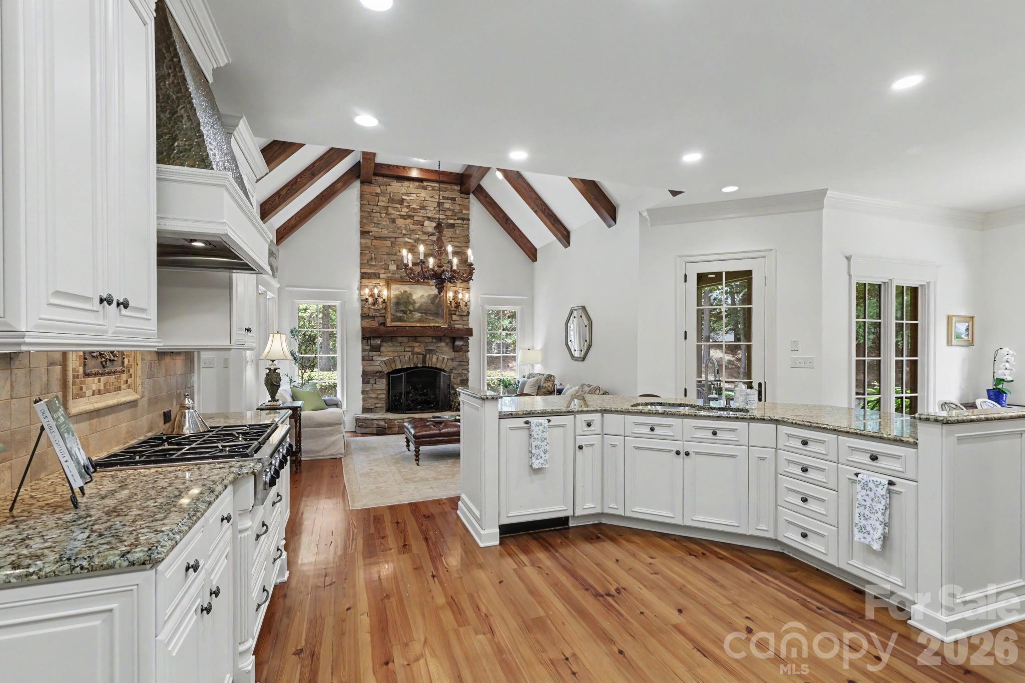 508 Hideaway Ridge Court Matthews, NC 28105 - Photo 19 of 47 a kitchen with granite countertop a stove a sink and a granite counter tops