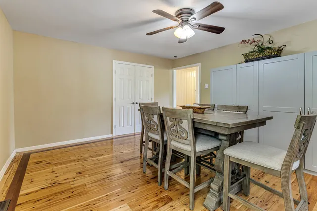 a view of a dining room with furniture and a chandelier