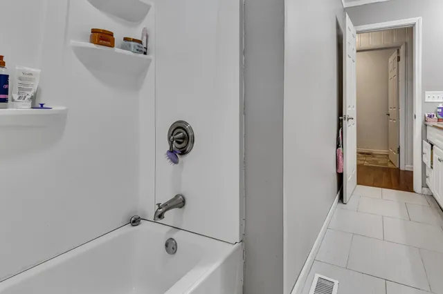 a bathroom with a tub and shower