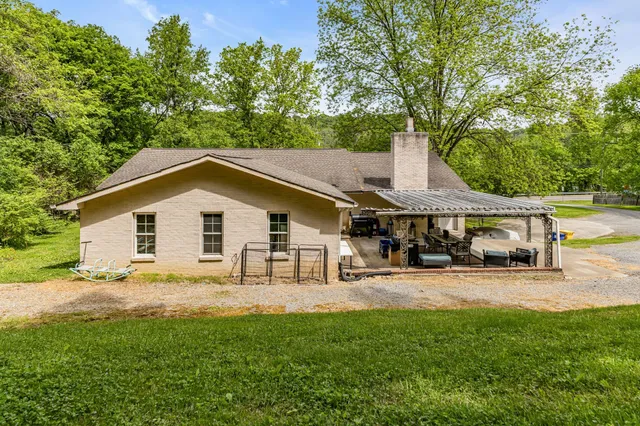 a view of a house with large outdoor space and sitting area