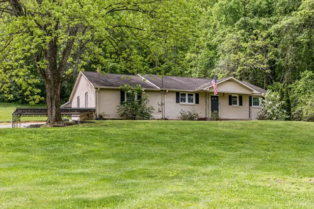 a front view of a house with a garden