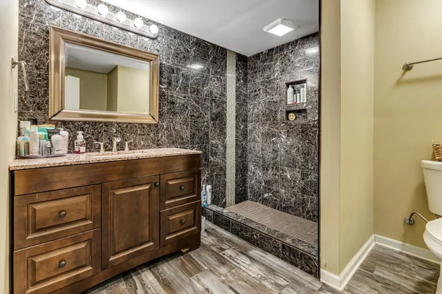 a bathroom with a sink a mirror and a shower