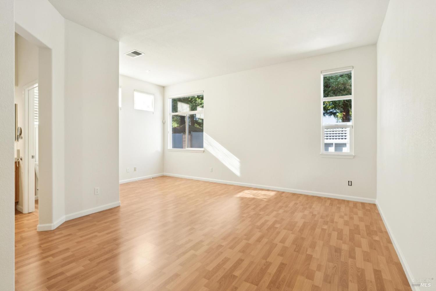 6471 Pine Valley Drive Santa Rosa, CA 95409 - Photo 24 of 48 an empty room with wooden floor and windows