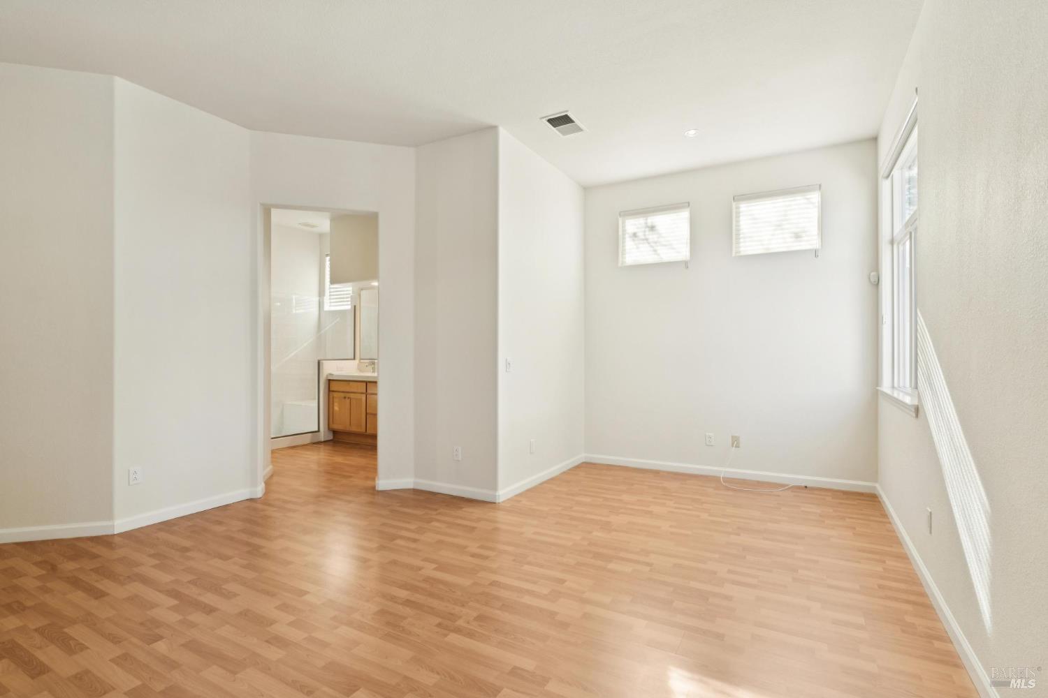 6471 Pine Valley Drive Santa Rosa, CA 95409 - Photo 25 of 48 a view of an empty room with wooden floor and a bathroom