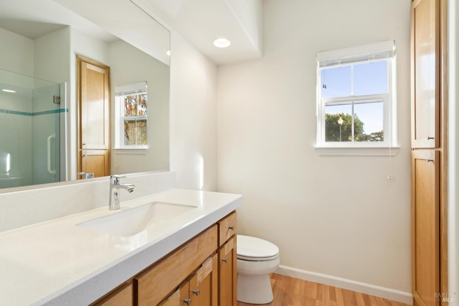 6471 Pine Valley Drive Santa Rosa, CA 95409 - Photo 33 of 48 a bathroom with a granite countertop sink a toilet and a mirror