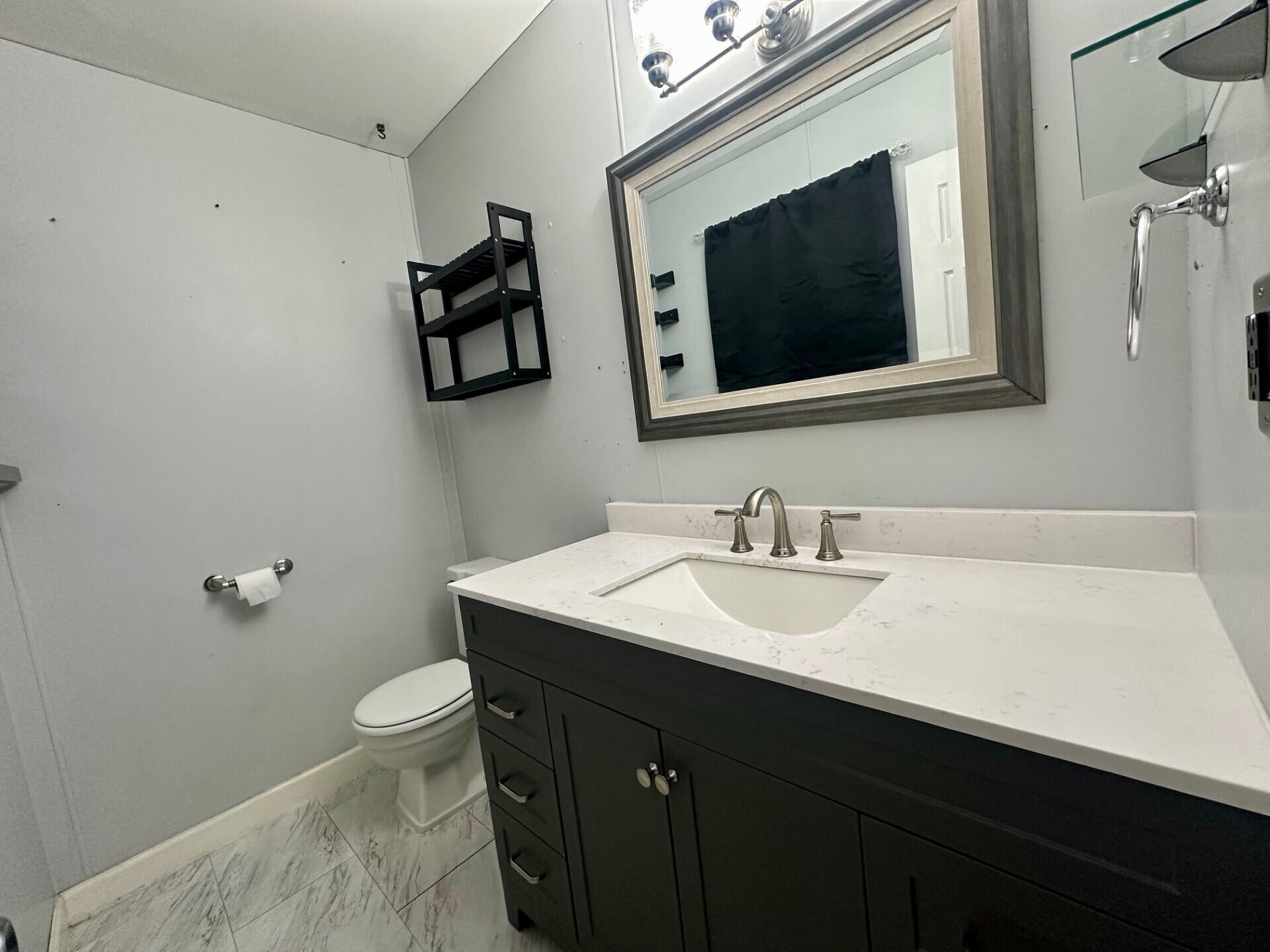 3907 Brookside Drive Crown Point, IN 46307 - Photo 16 of 22 a bathroom with a sink toilet and mirror