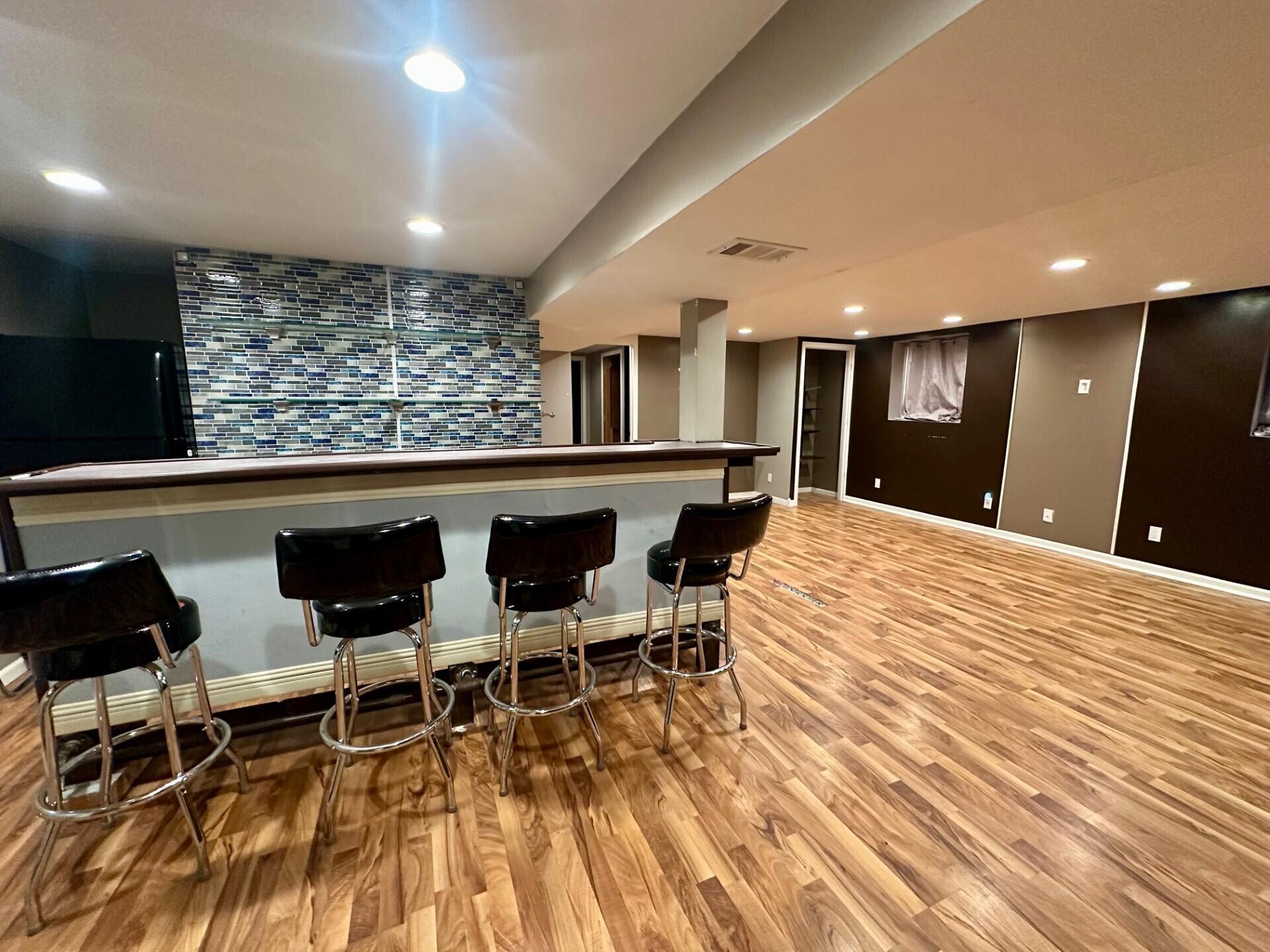 3907 Brookside Drive Crown Point, IN 46307 - Photo 4 of 22 a large white kitchen with a sink and chairs
