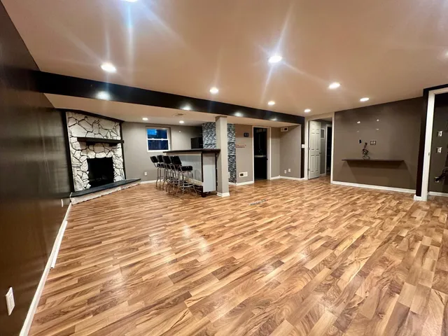 a large room with kitchen view and a window