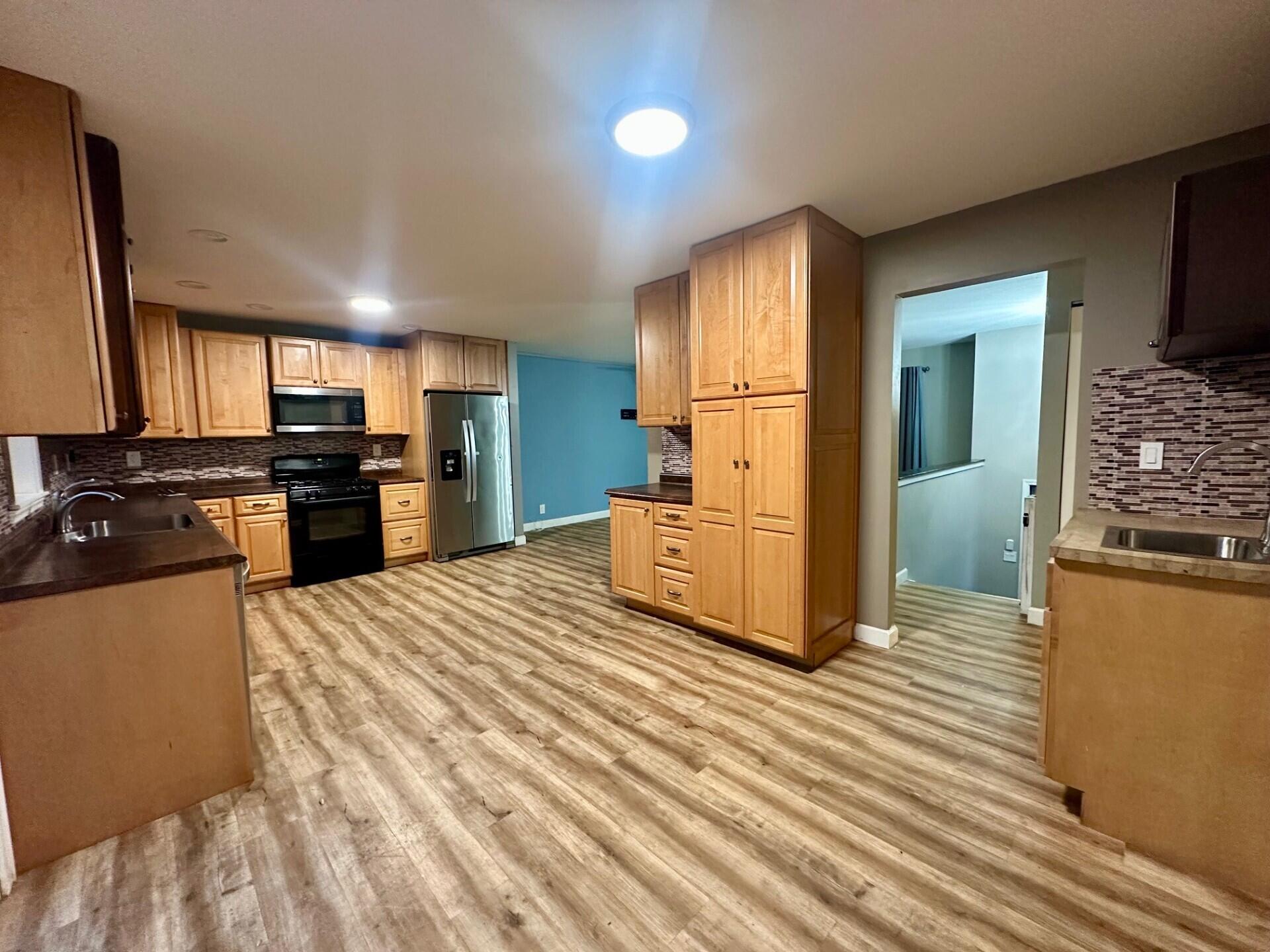 3907 Brookside Drive Crown Point, IN 46307 - Photo 7 of 22 a kitchen with stainless steel appliances kitchen island granite countertop a refrigerator and a stove top oven