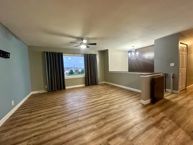 a view of a kitchen with a sink and a refrigerator