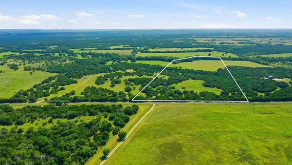 an aerial view of a houses with a yard