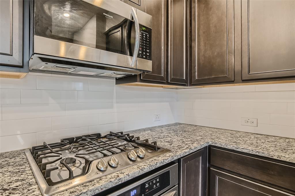 2407 Siskiyou Street Lewisville, TX 75056 - Photo 13 of 31 a stove top oven sitting inside of a kitchen