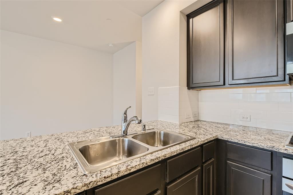 2407 Siskiyou Street Lewisville, TX 75056 - Photo 14 of 31 a kitchen with sink cabinets and granite