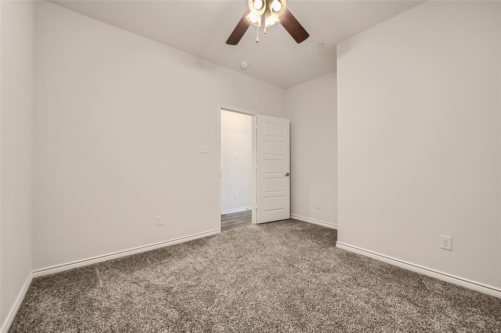 2407 Siskiyou Street Lewisville, TX 75056 - Photo 15 of 31 an empty room with a ceiling fan and carpet