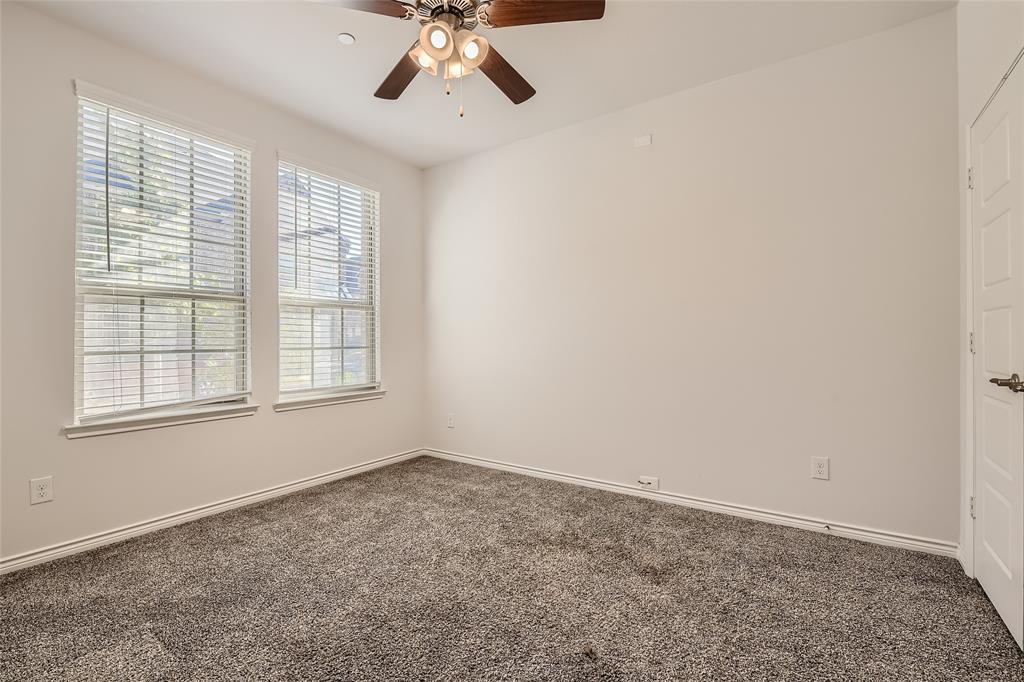 2407 Siskiyou Street Lewisville, TX 75056 - Photo 16 of 31 an empty room with windows and chandelier fan