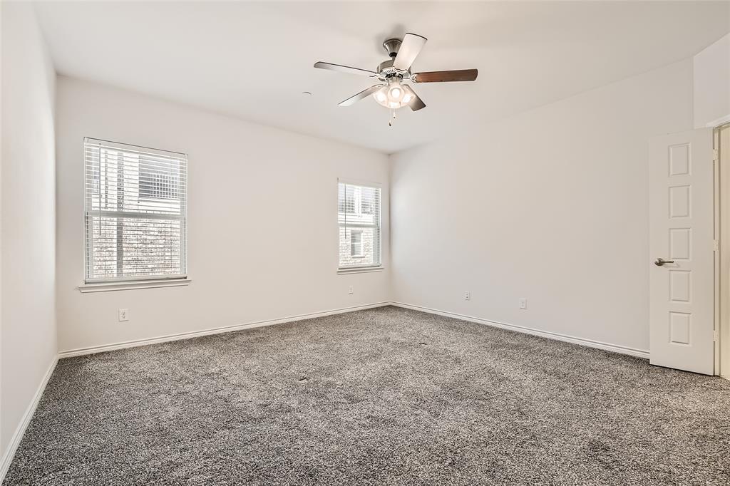 2407 Siskiyou Street Lewisville, TX 75056 - Photo 18 of 31 an empty room with windows and fan