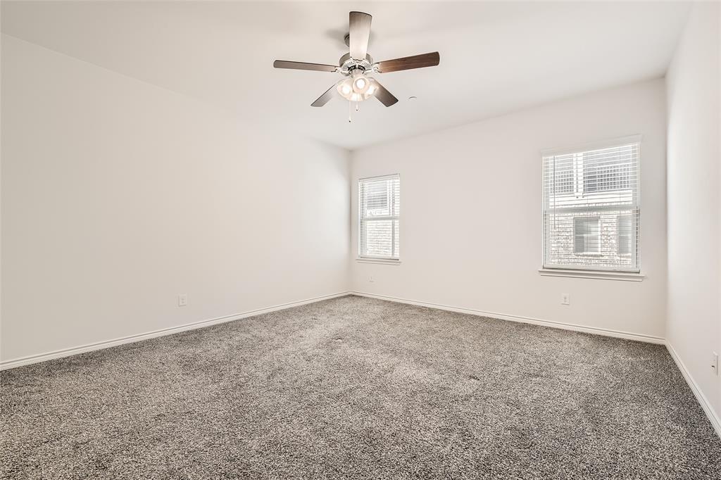2407 Siskiyou Street Lewisville, TX 75056 - Photo 19 of 31 an empty room with windows and fan