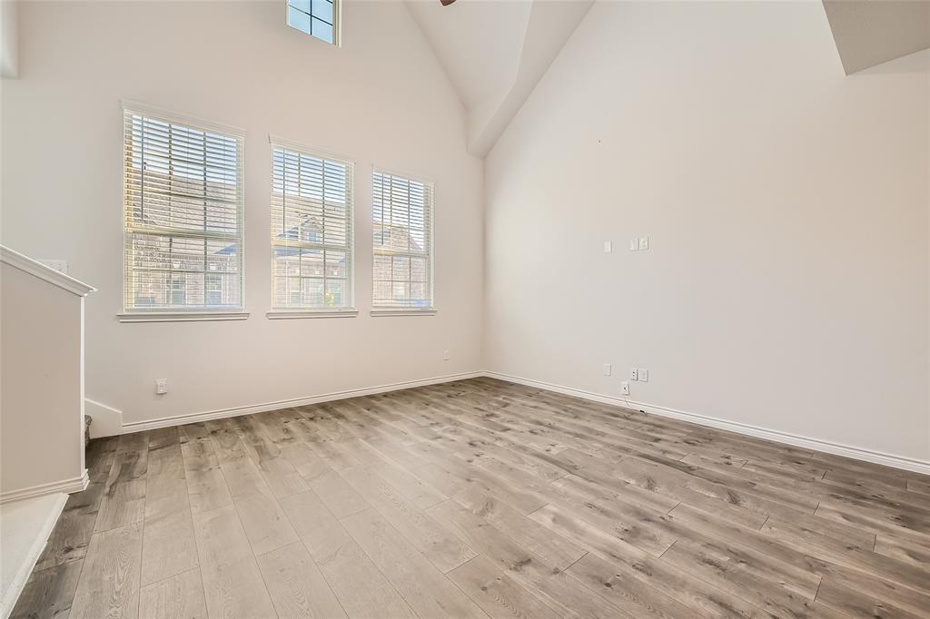 2407 Siskiyou Street Lewisville, TX 75056 - Photo 24 of 31 an empty room with wooden floor and windows