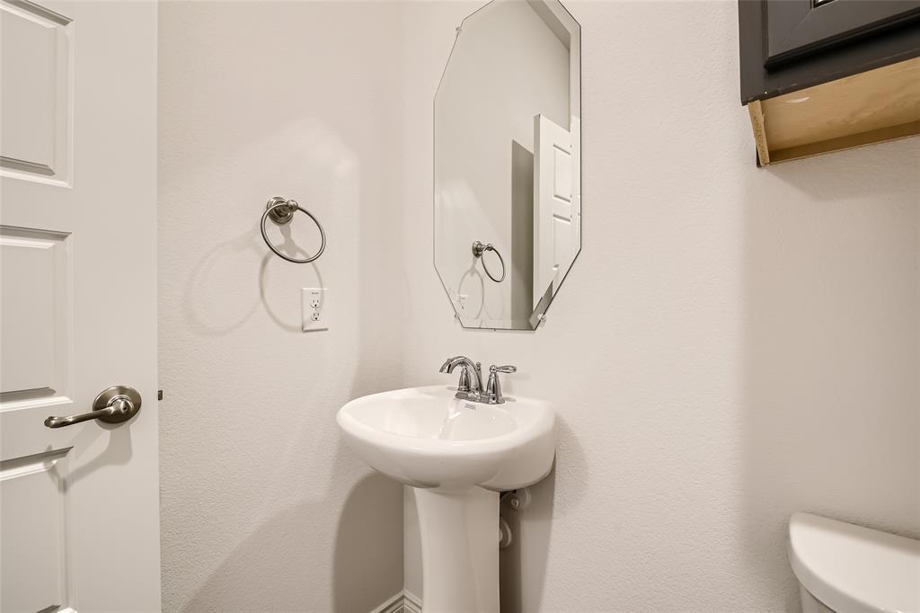2407 Siskiyou Street Lewisville, TX 75056 - Photo 25 of 31 a bathroom with a sink and mirror