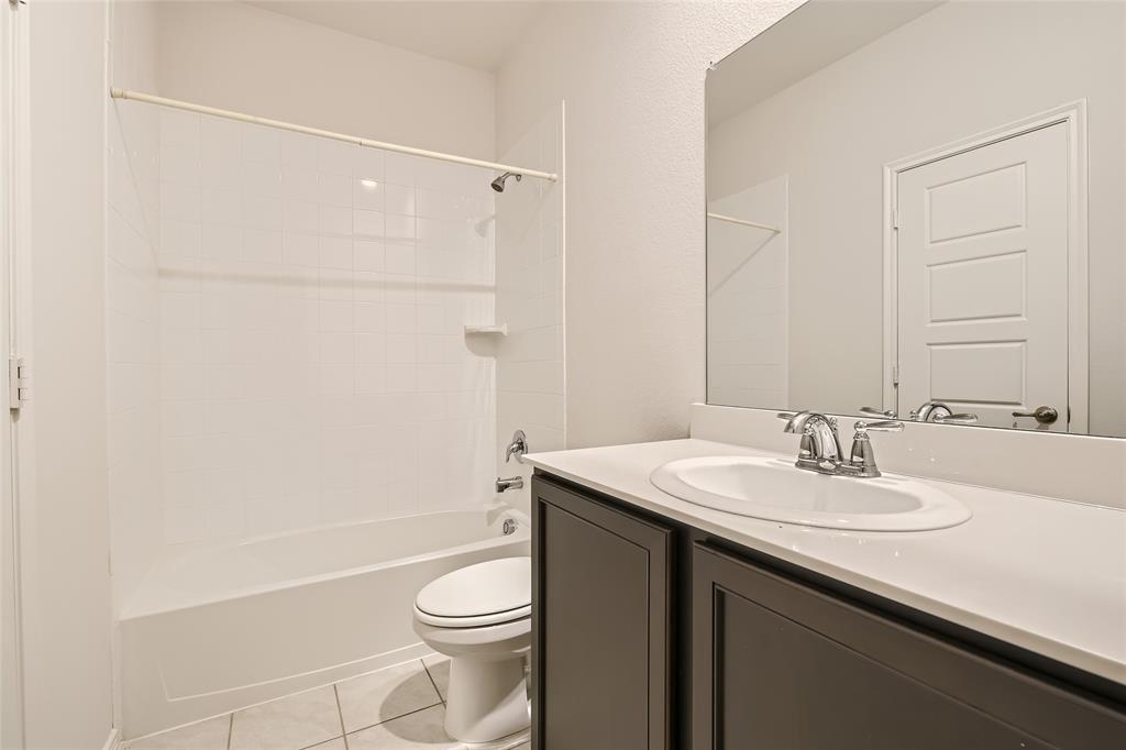 2407 Siskiyou Street Lewisville, TX 75056 - Photo 27 of 31 a bathroom with a sink a toilet and shower
