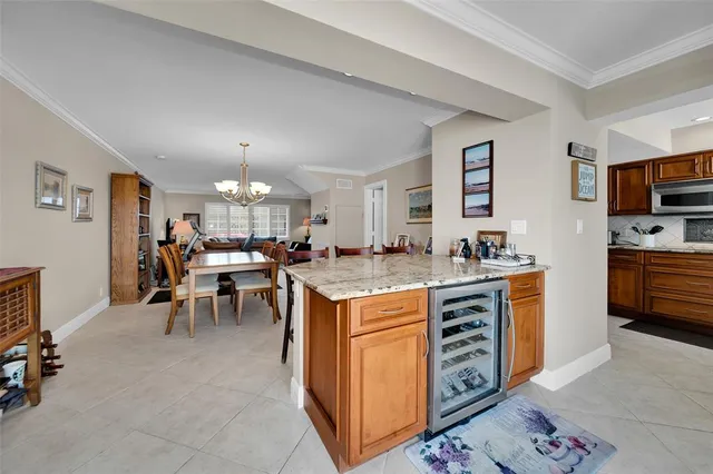 a open kitchen with stainless steel appliances granite countertop a stove and a refrigerator
