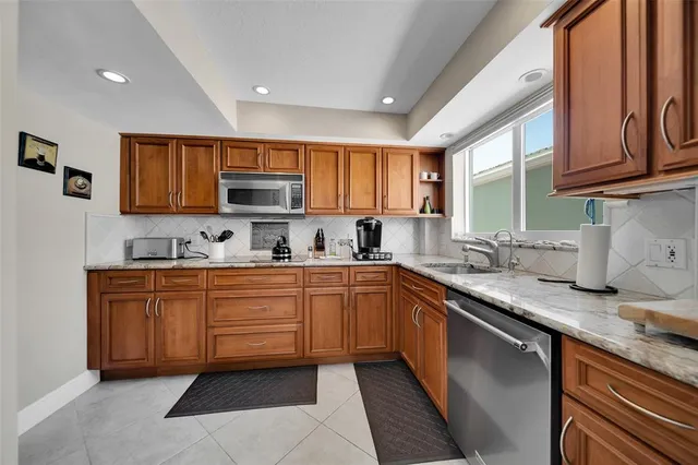 a kitchen with stainless steel appliances granite countertop a sink and cabinets