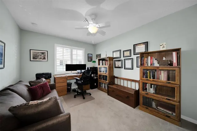 a livingroom with workspace and a couch