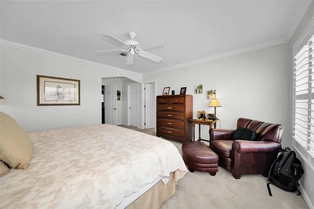 a bedroom with a bed a couch and a window