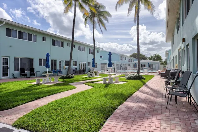 a view of a swimming pool with a table and chairs