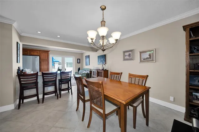a view of a dining room with furniture and chandelier