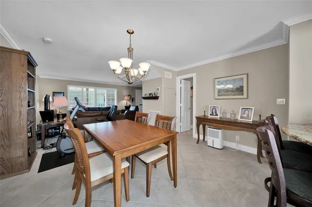 a view of a dining room with furniture and chandelier