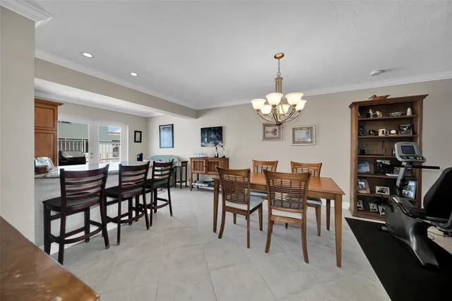 a view of a dining room with furniture and chandelier