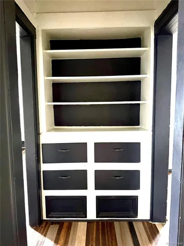 a view of walk in closet with empty racks