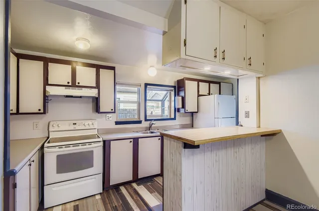 a kitchen with stainless steel appliances granite countertop a sink and cabinets
