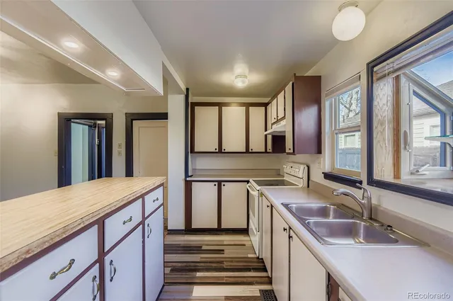a bathroom with a granite countertop sink and a large mirror