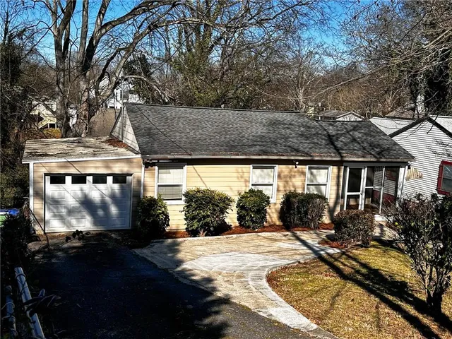 a view of a house with backyard and sitting area