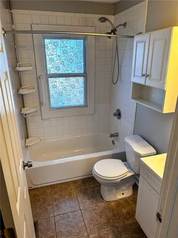 a bathroom with a bath tub a sink and a toilet